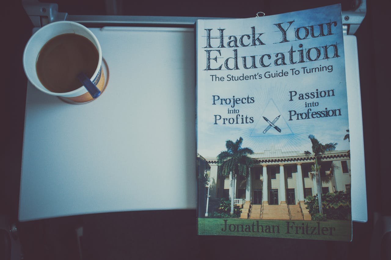 A book and cup of coffee on a tray table, promoting education and travel.